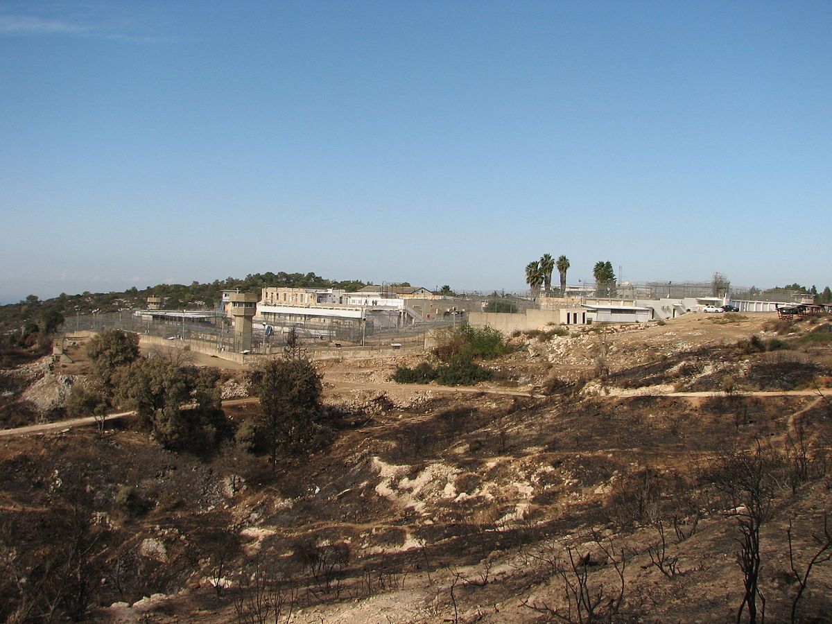 An Israeli prison in the vicinity of a depopulated Palestinian village. The prison is surrounded by deforested terrain and ringed by watchtowers.