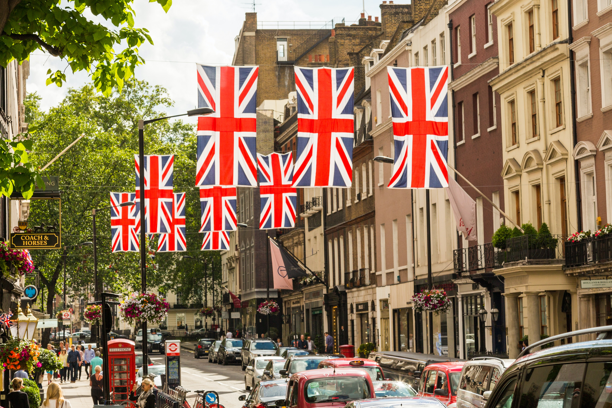 A street in London, with Unions Jack banners hanging down above the road.